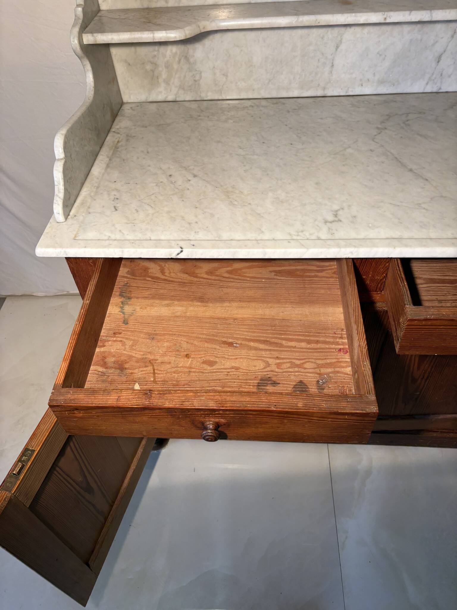 Antique wood and marble kitchen sideboard with carved backsplash