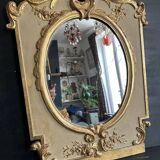 Napoleon III mirror in carved gilded wood, oval mercury glass.