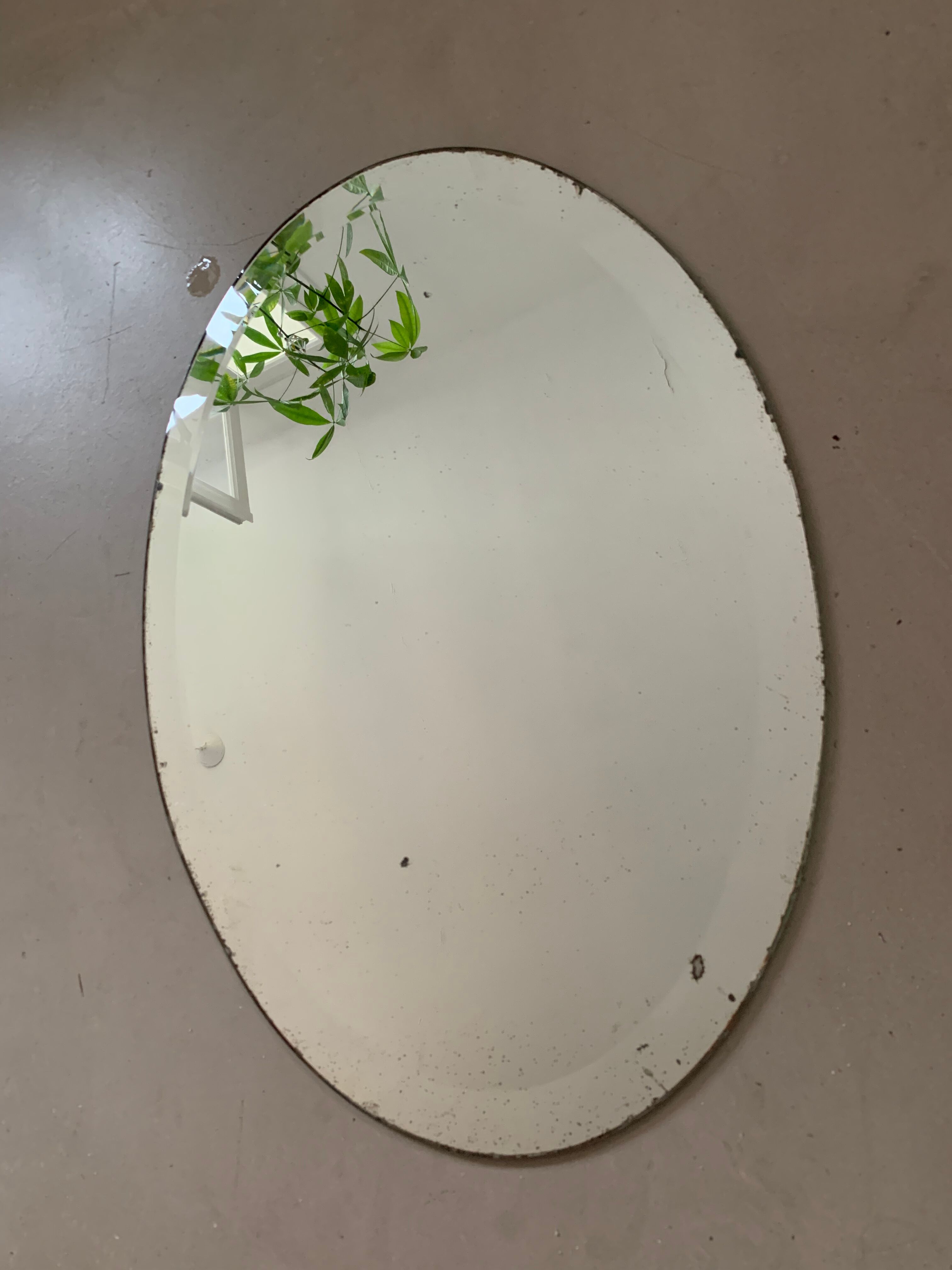 Old bevelled stitched oval mirror
