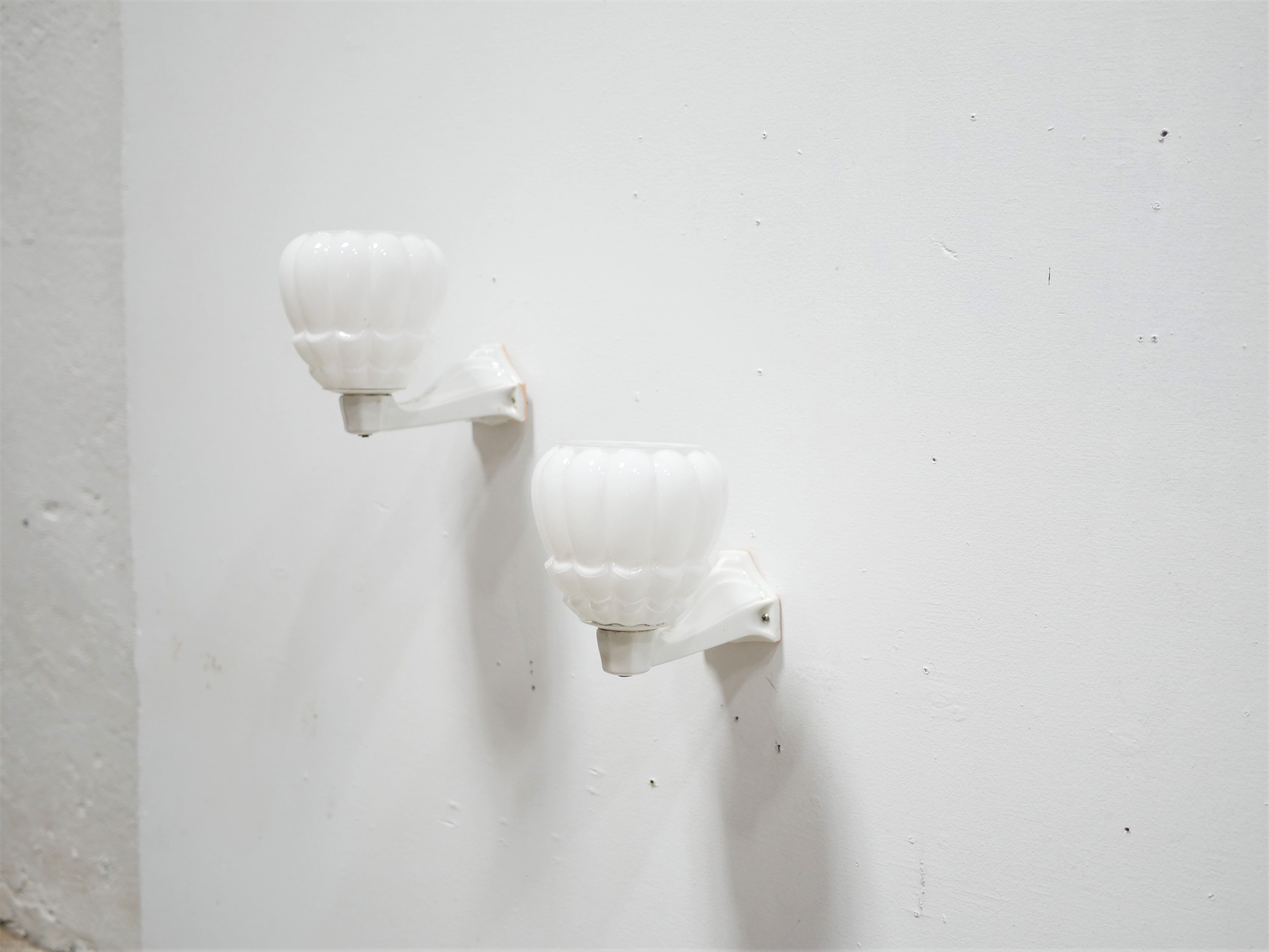 Pair of art deco porcelain and glass wall appliques