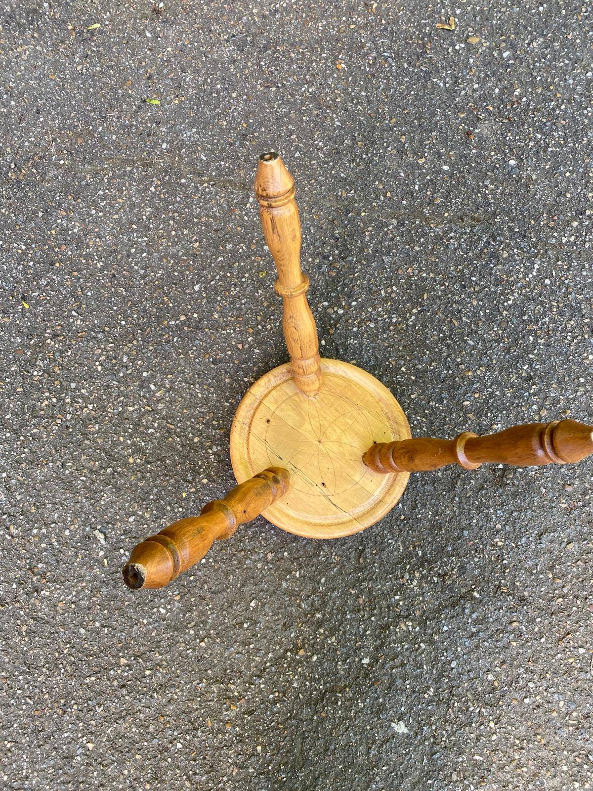 Vintage low tripod stool with carved light oak legs.