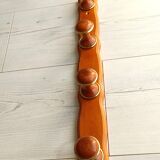 Wall-mounted coat rack in wood and brass