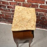 Wooden bedside table topped with a pink marble top