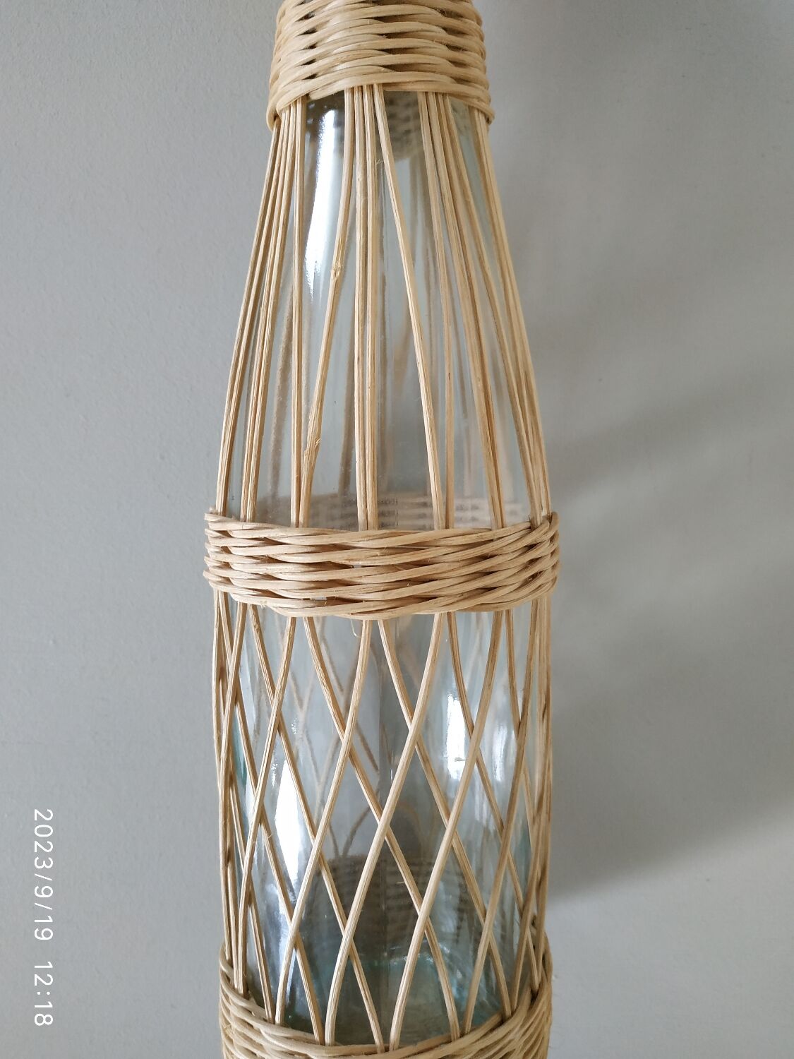Glass and rattan bottle