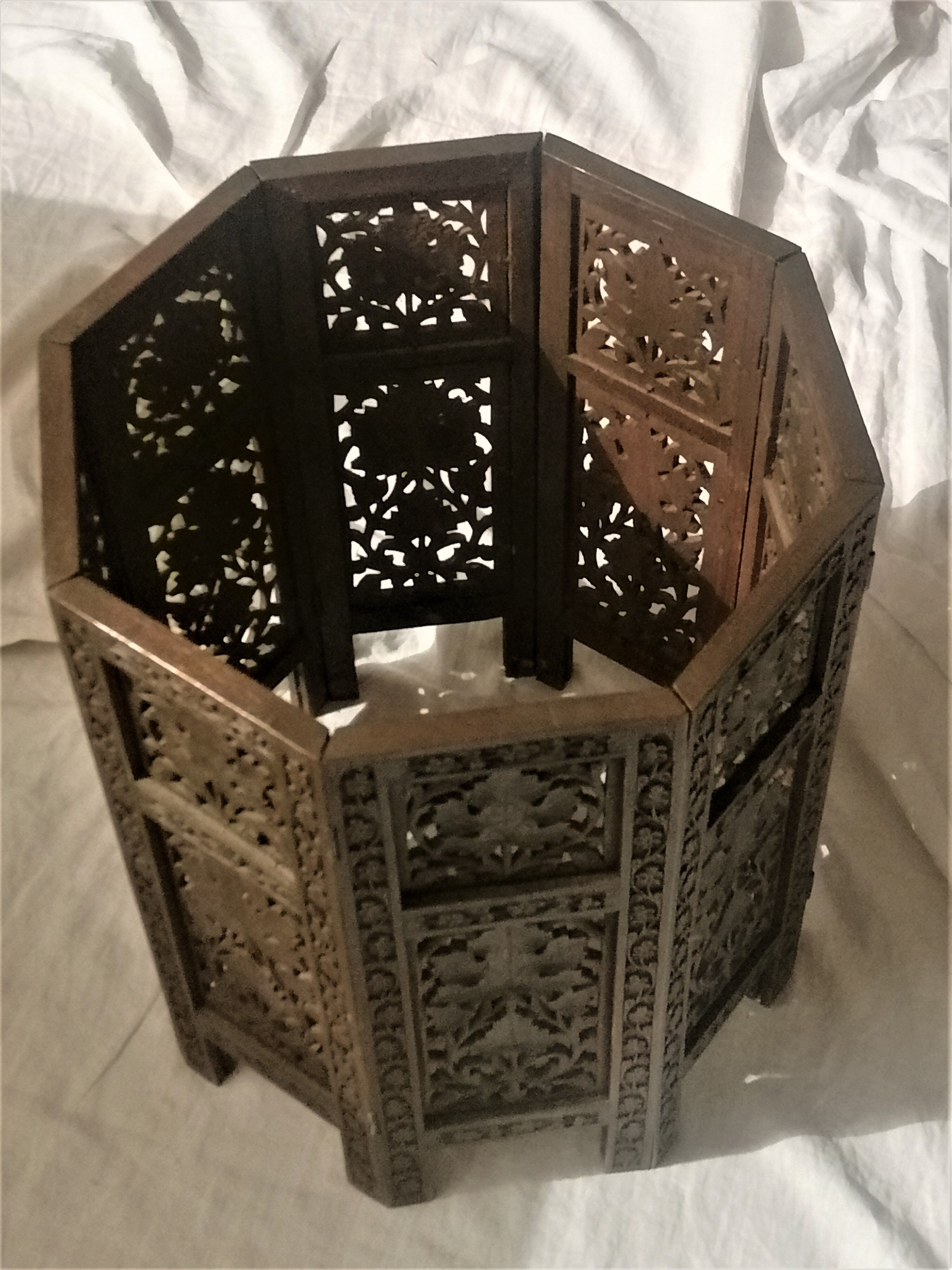 Ancient oriental pedestal table in carved wood