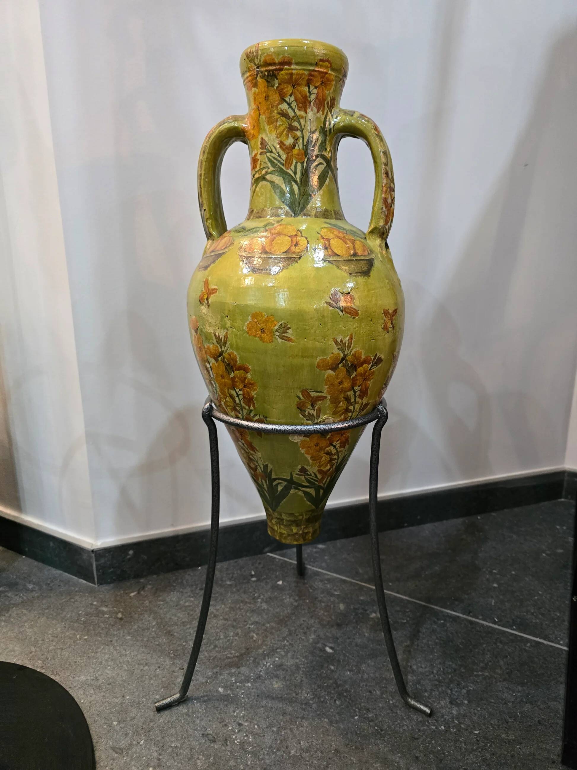 Large decorative vase with handles – painted floral design – on a metal stand