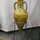 Large decorative vase with handles – painted floral design – on a metal stand