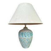 Vintage green ceramic table lamp with a worn lampshade.