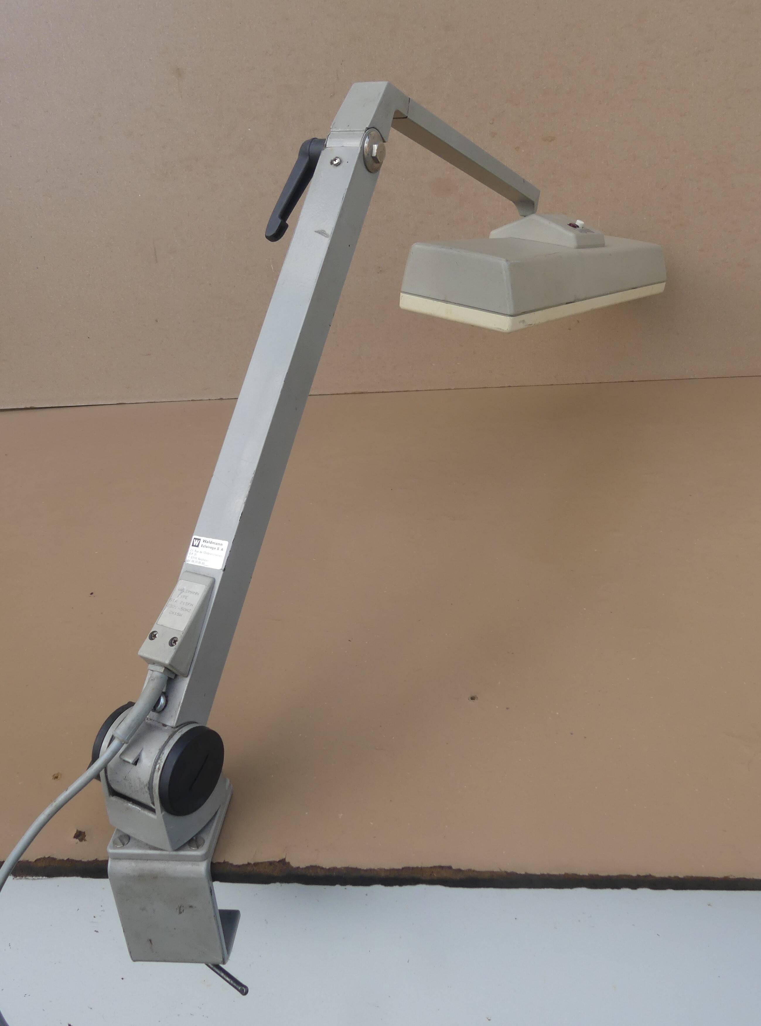 WALDMANN articulated workshop lamp with two industrial clamp arms for architects.