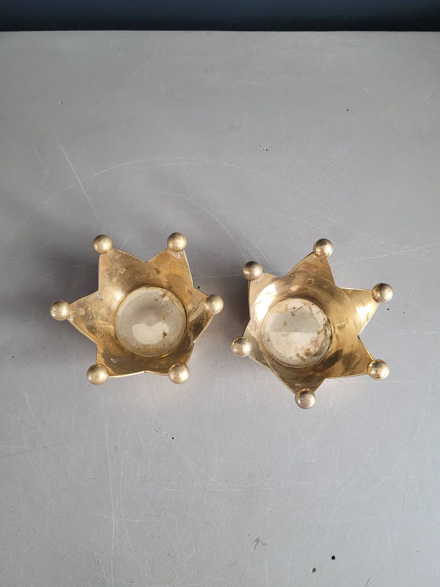 Pair of crown candle holders in brass