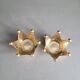 Pair of crown candle holders in brass