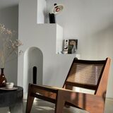 Reclined armchair in canned teak in natural wood