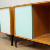 A pair of vintage mid-century bedside tables with glass sliding doors
