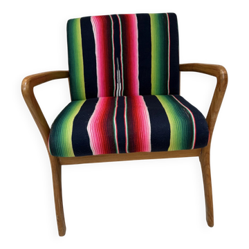 Scandinavian-style armchair in curved wood and colourful striped fabric.