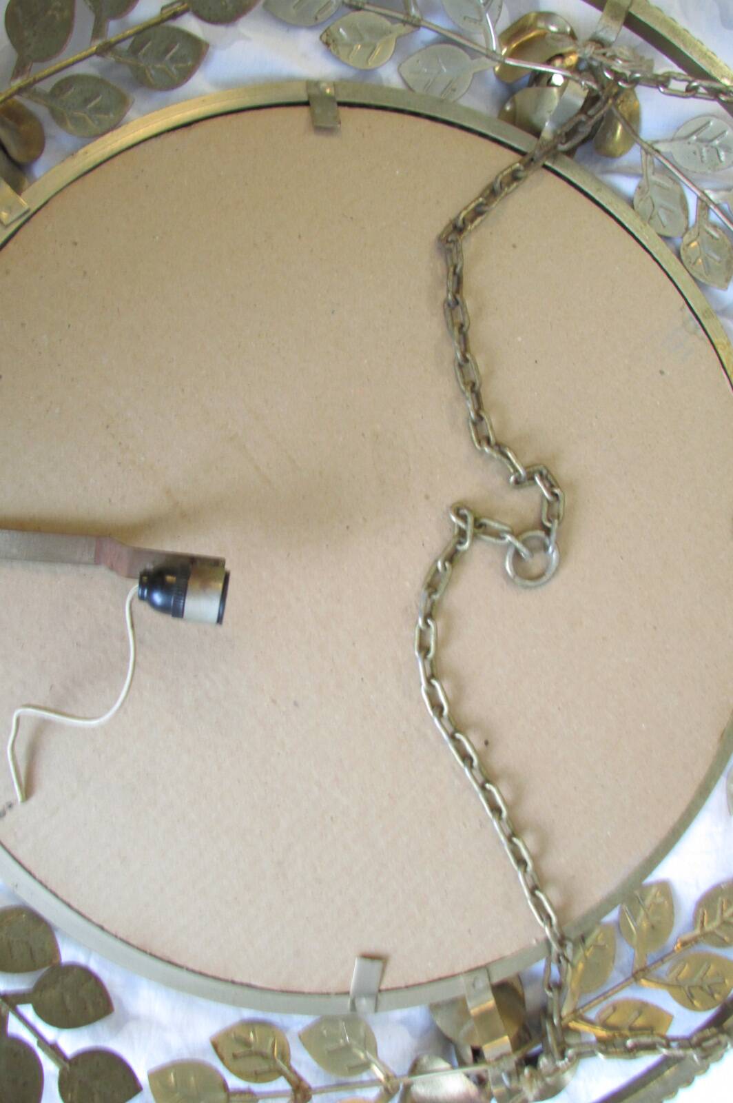 Round gold metal mirror, rose crown