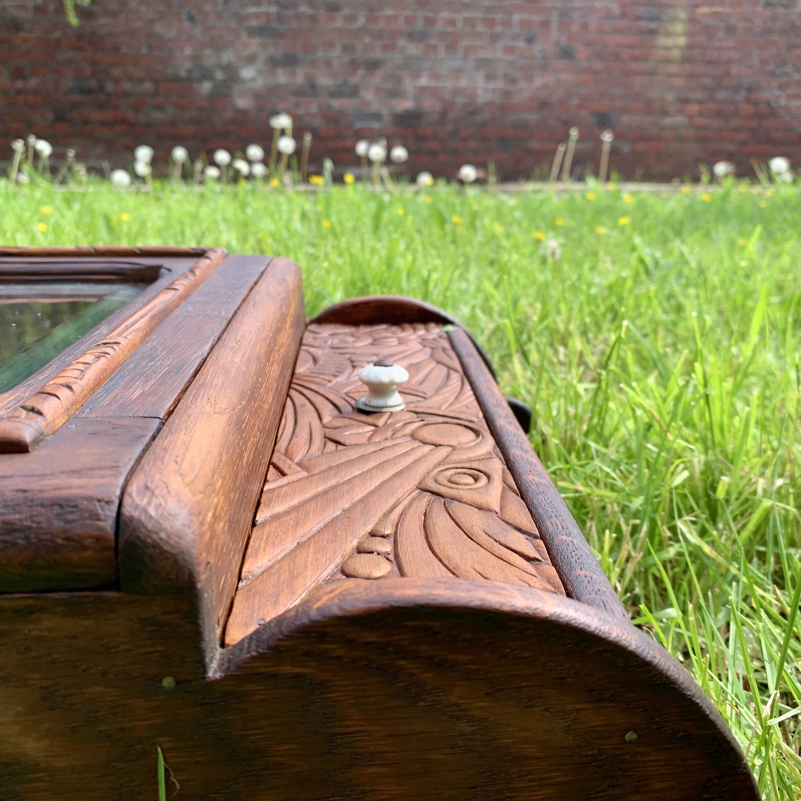 Old carved wooden medicine cabinet with beveled mirror