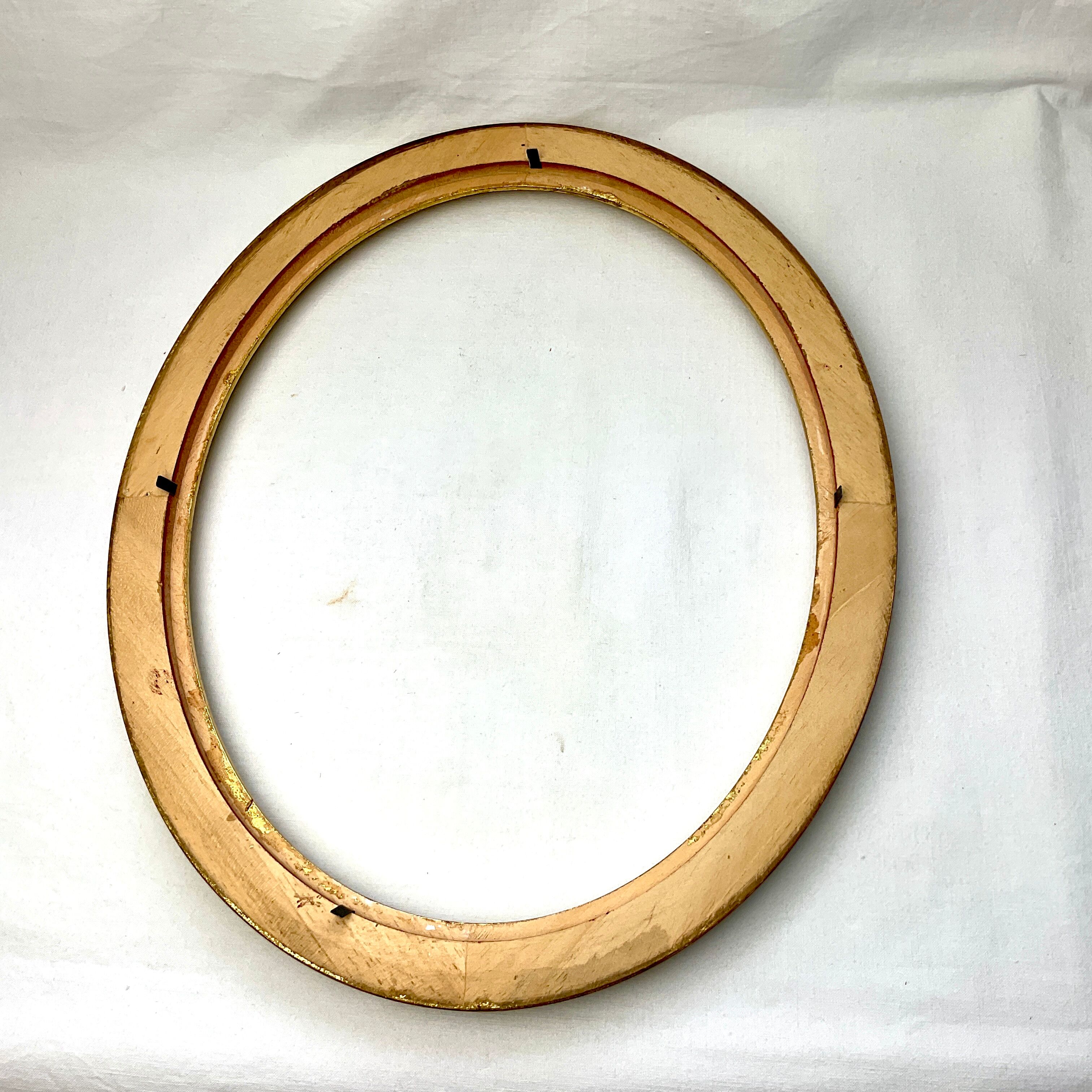 Old oval gilded wooden frame with domed glass