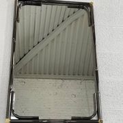 Mirror in black metal and brass with gunmetal finish