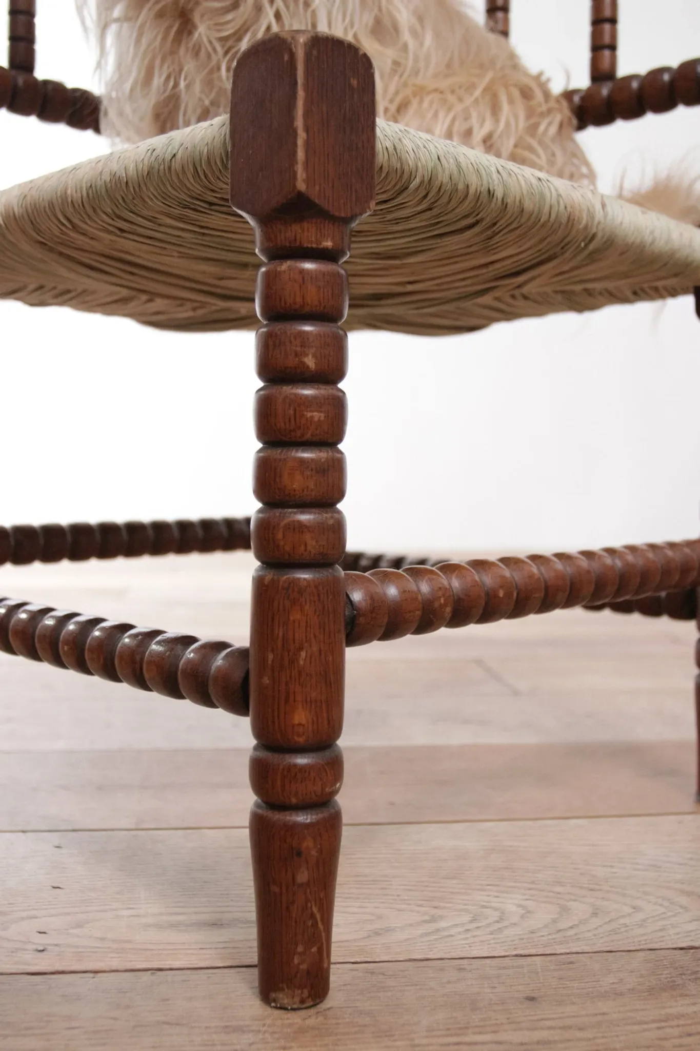 Antique Dutch oak corner chair with turned spindles and new rush seat