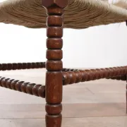 Antique Dutch oak corner chair with turned spindles and new rush seat