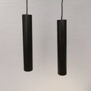 Two cylinder-shaped hanging lamps in black lacquer