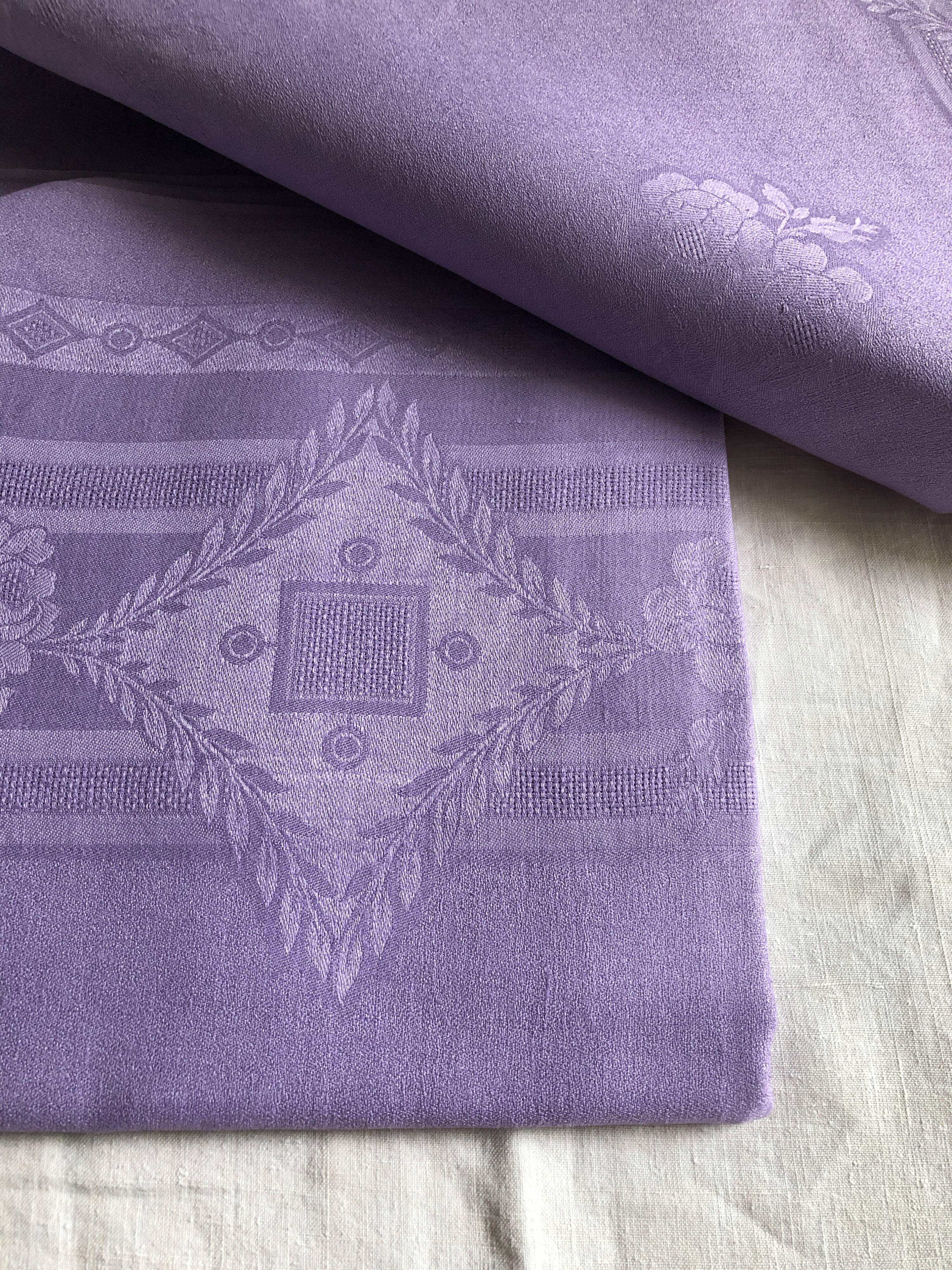 Old damask tablecloth in linen and purple silk