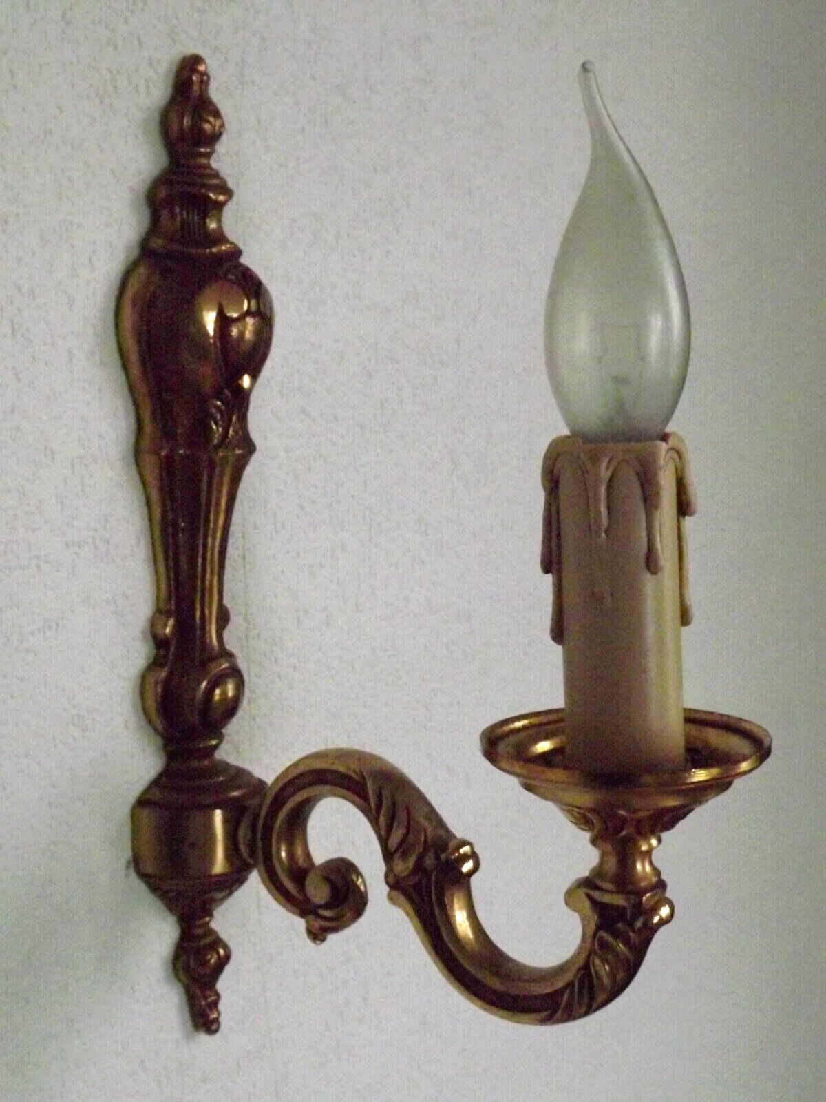 Simple wall sconce in classic Empire style in vintage French bronze.