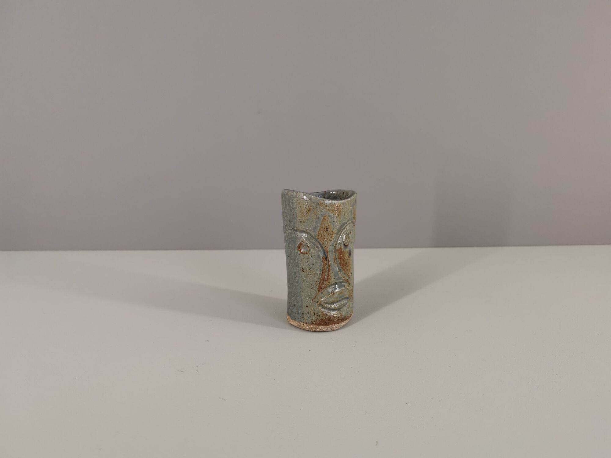 Signed vase in enamelled sandstone with stylized face