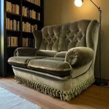 Vintage green two-seater sofa with fringes