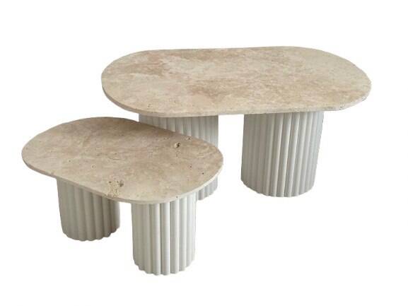 Oval coffee table duo travertine and white fluted wooden legs.