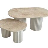 Oval coffee table duo travertine and white fluted wooden legs.
