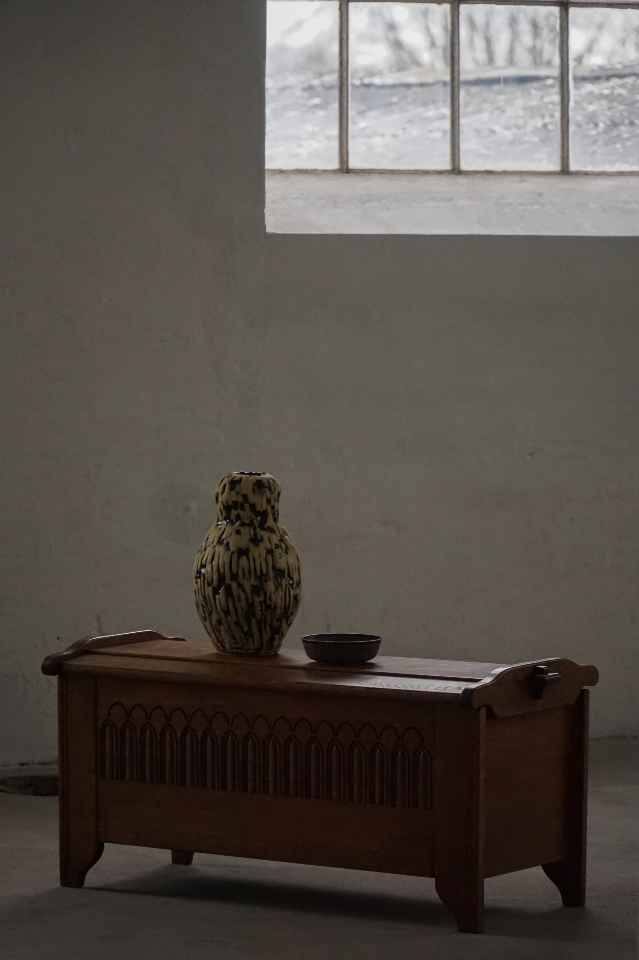 Modern Danish oak commode with decorative relief sculpture, mid-20th century.