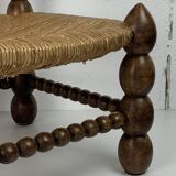 Brutalist wood turned bobbin low rush chair in the style of Charles Dudouyt