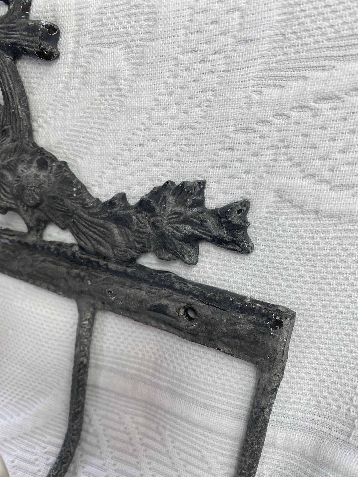 Patinated metal wall bracket and porcelain