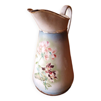 Old enameled sheet metal pitcher with floral decorations