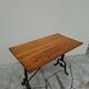 Solid oak bistro table with a cast iron base, signed.