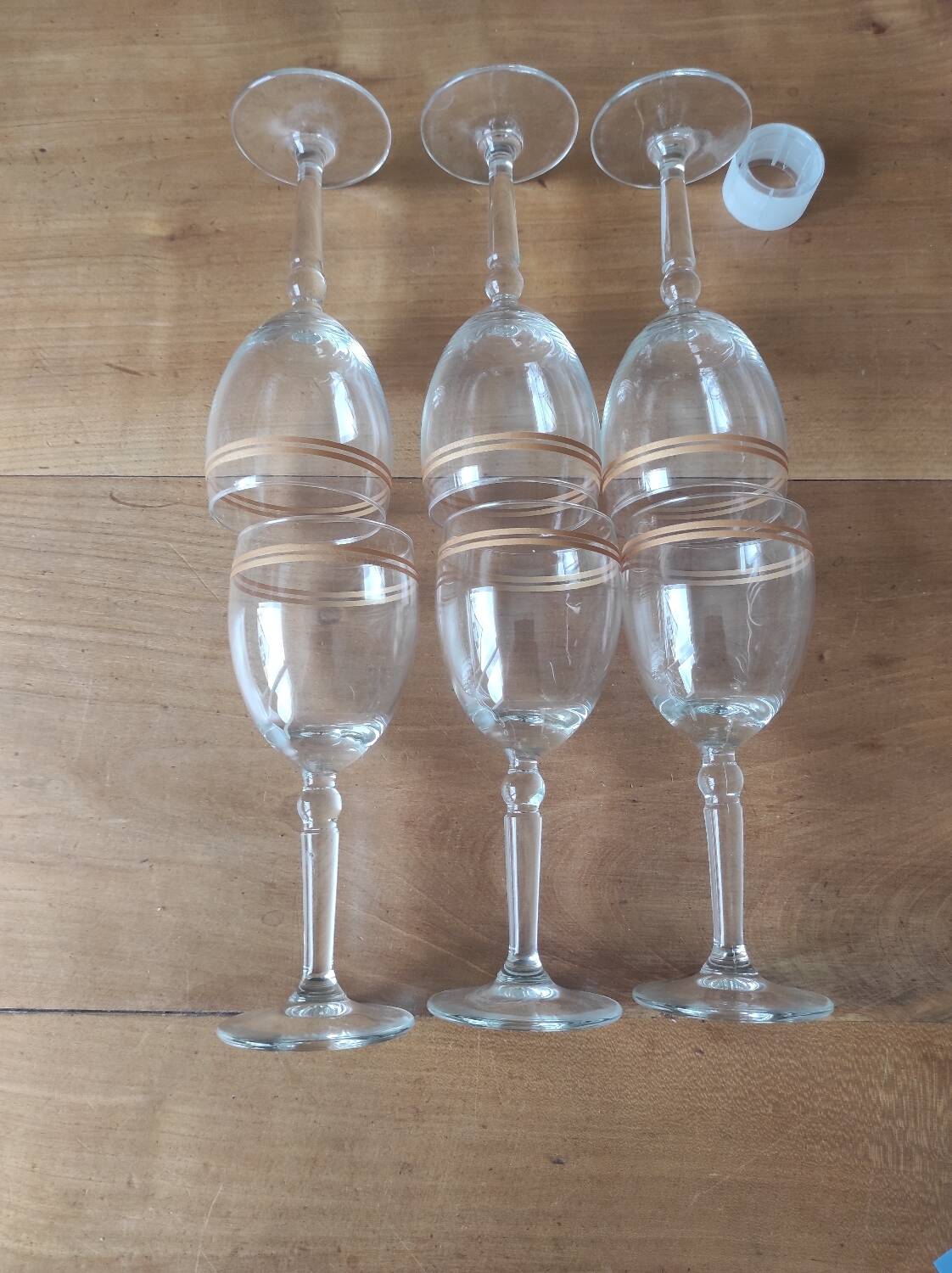 Set of 6 glasses with gold band decorations.