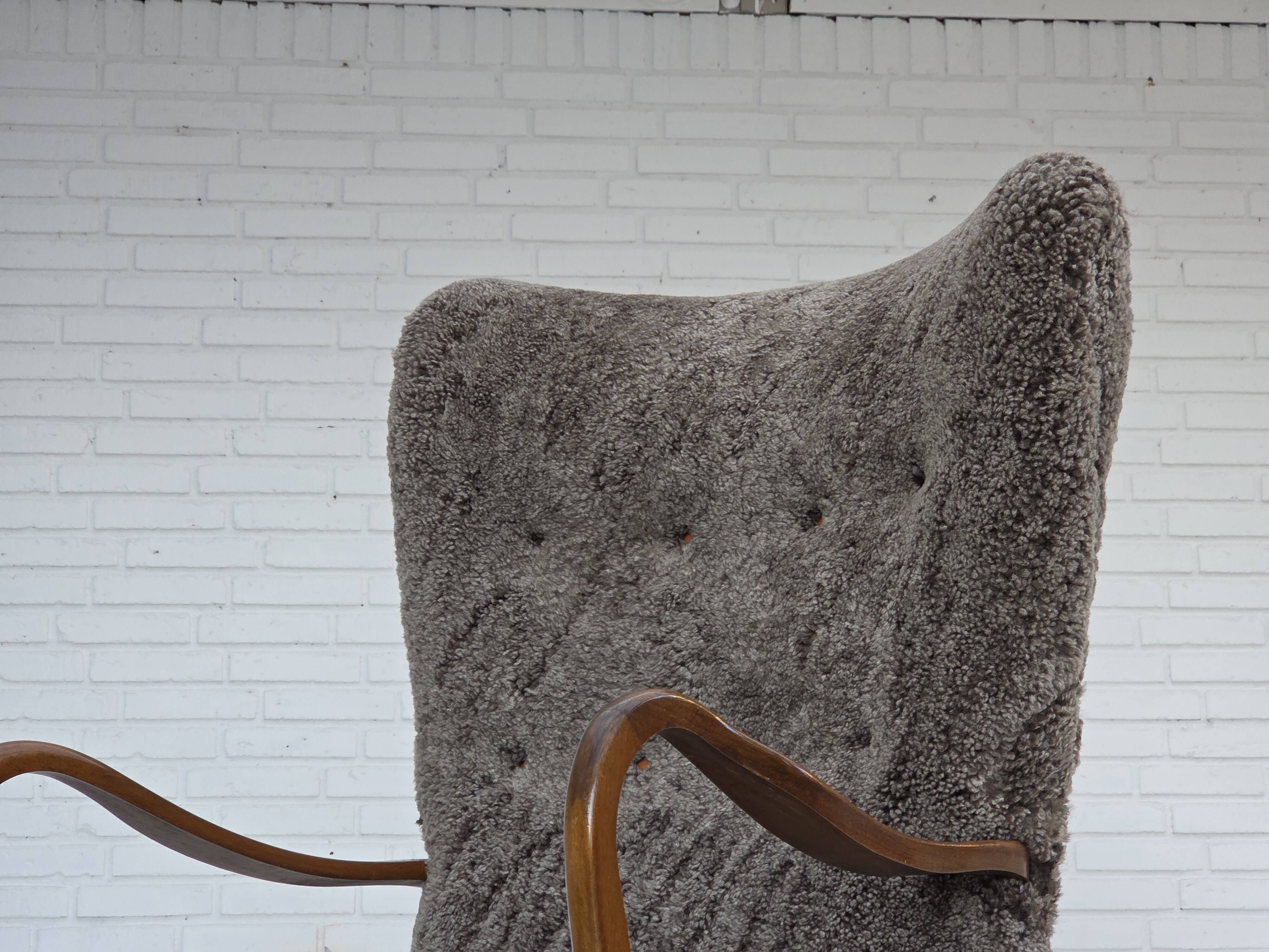 1960s, reupholstered Danish armchair, with stool, genuine sheepskin.