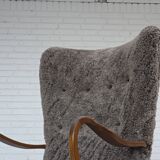 1960s, reupholstered Danish armchair, with stool, genuine sheepskin.
