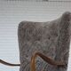 1960s, reupholstered Danish armchair, with stool, genuine sheepskin.