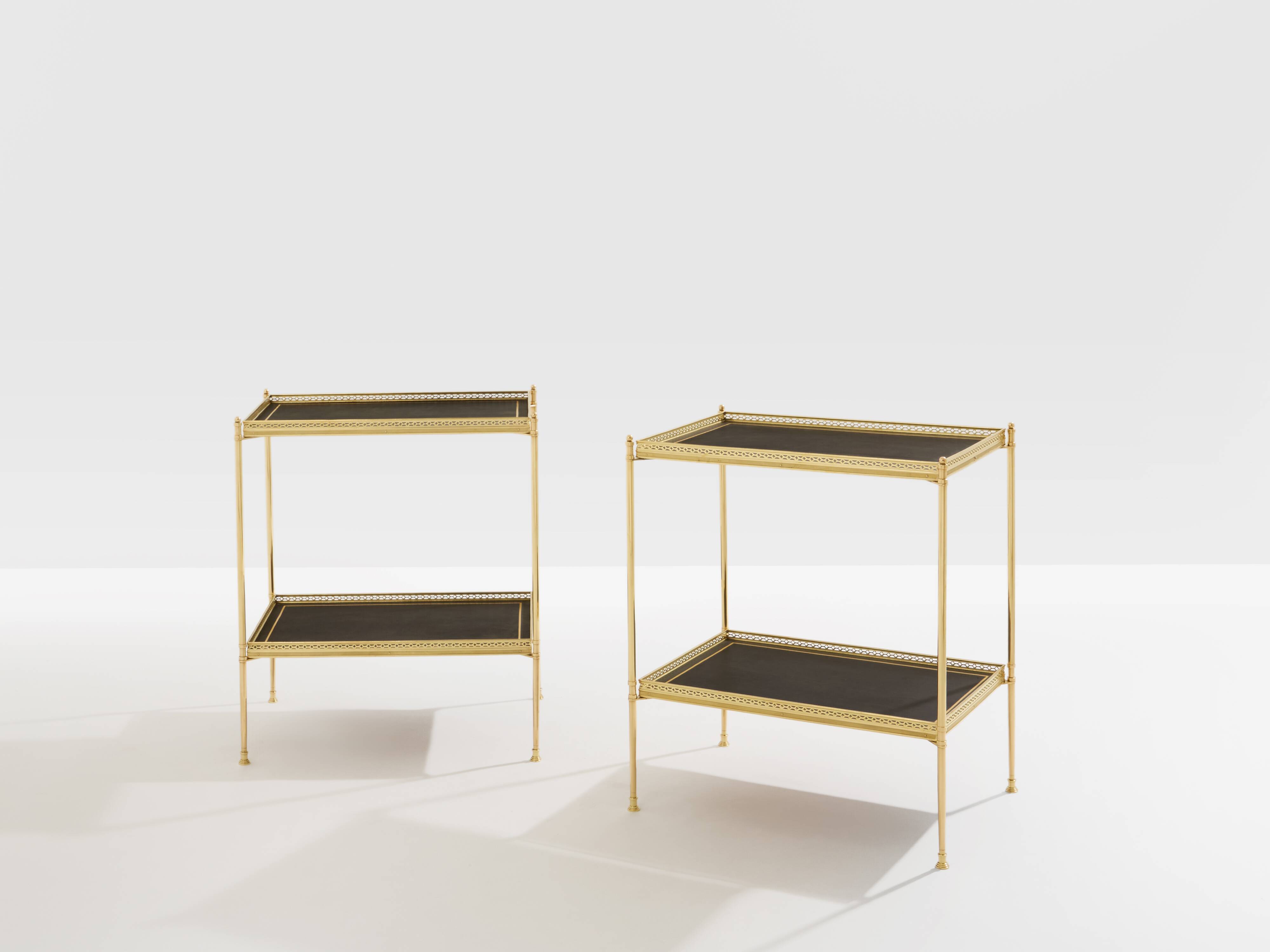 Pair of neoclassical side tables in brass and black leather by Maison Jansen, 1960.