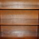 Corner library made of flamed hardwood, in 3 parts.