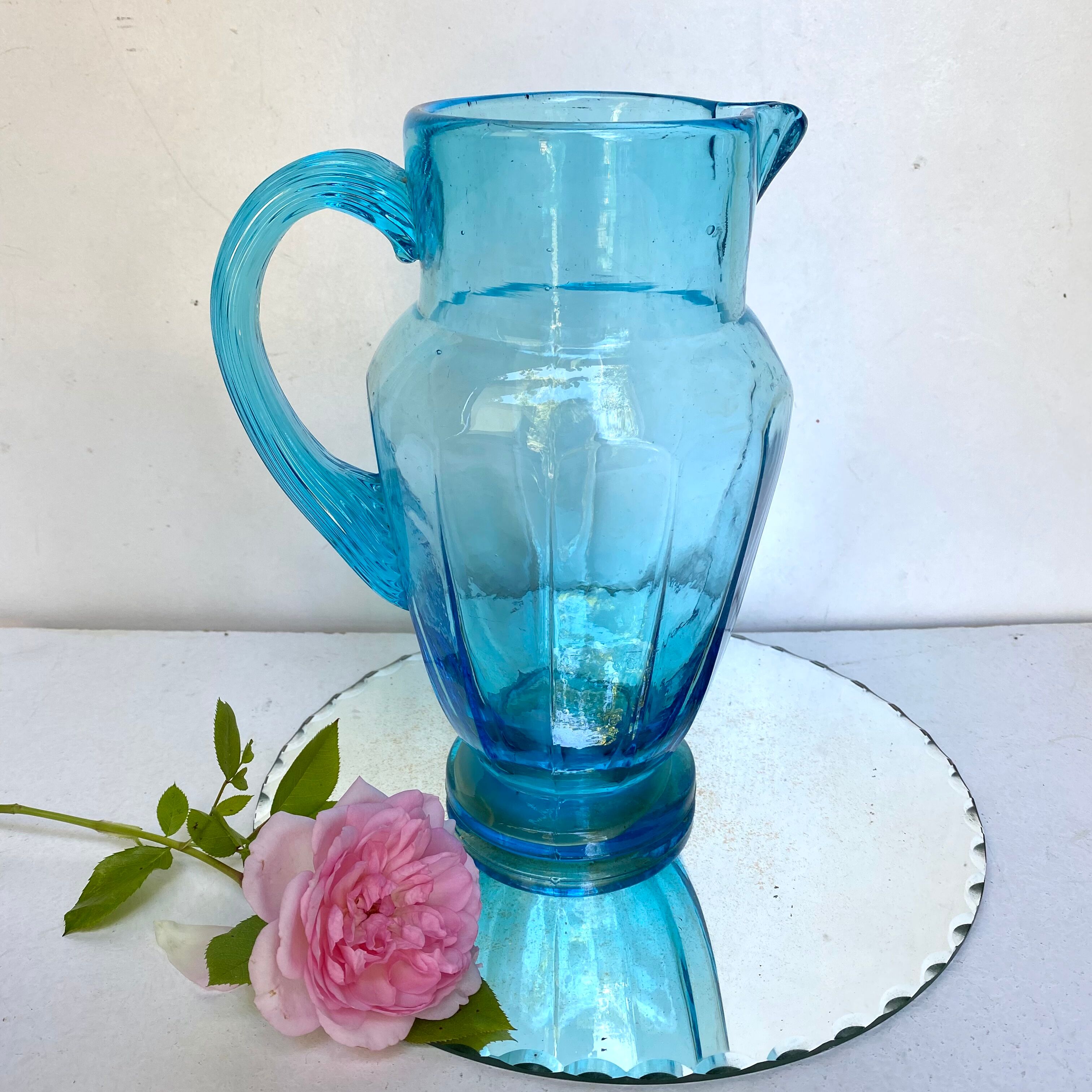 Old pitcher in blue glass