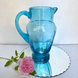 Old pitcher in blue glass