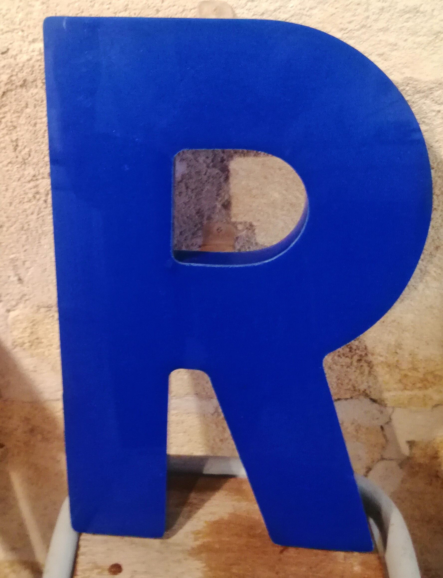 Letter R vintage sign in blue plexiglass