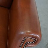 Cognac-colored leather wingback chair in English style