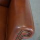Cognac-colored leather wingback chair in English style