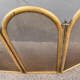 Antique brass fireplace screen from 1920, vintage spark guard.