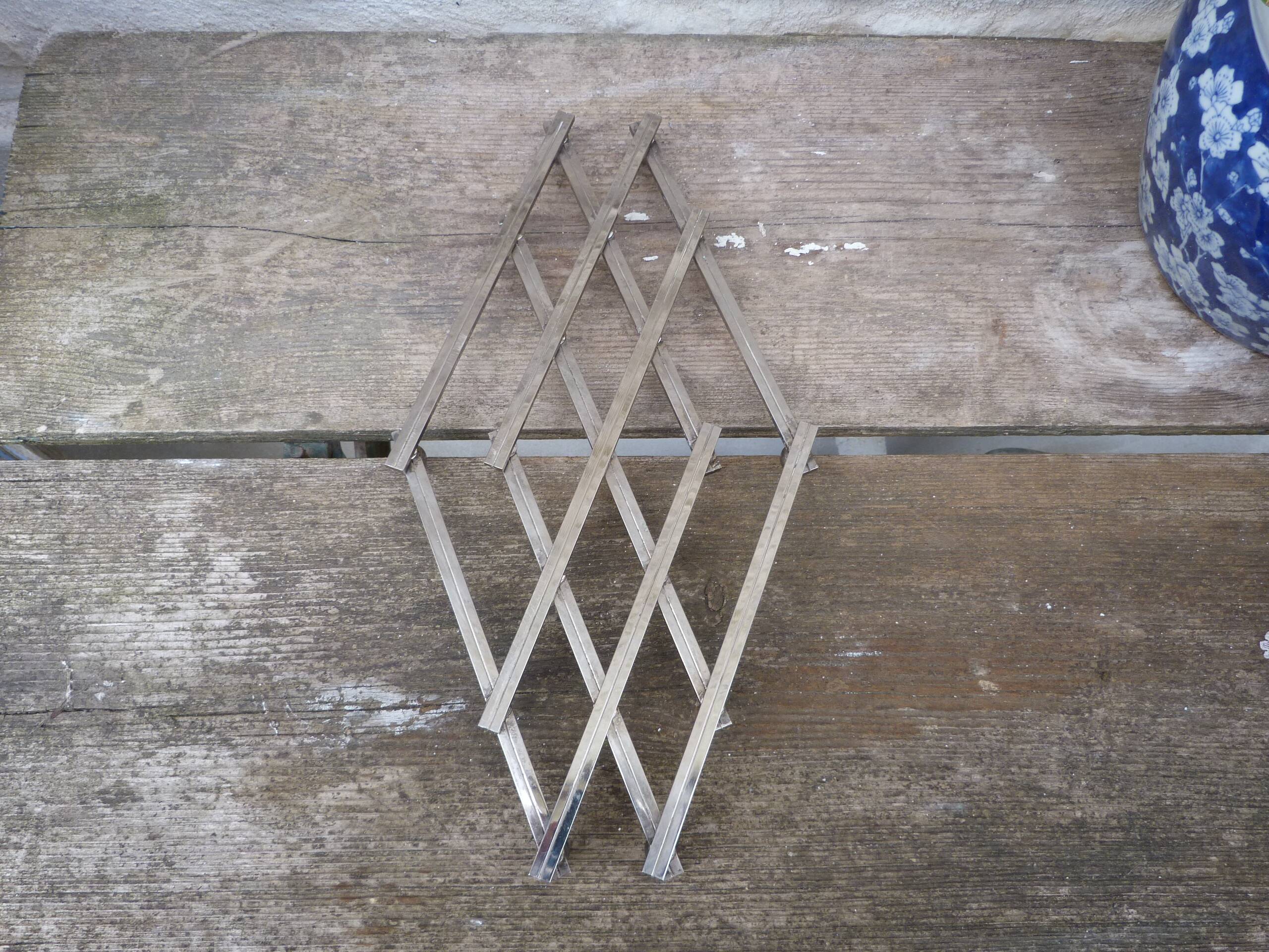 Modernist design foldable trivet in silver metal Jacques Adnet 1940/1950