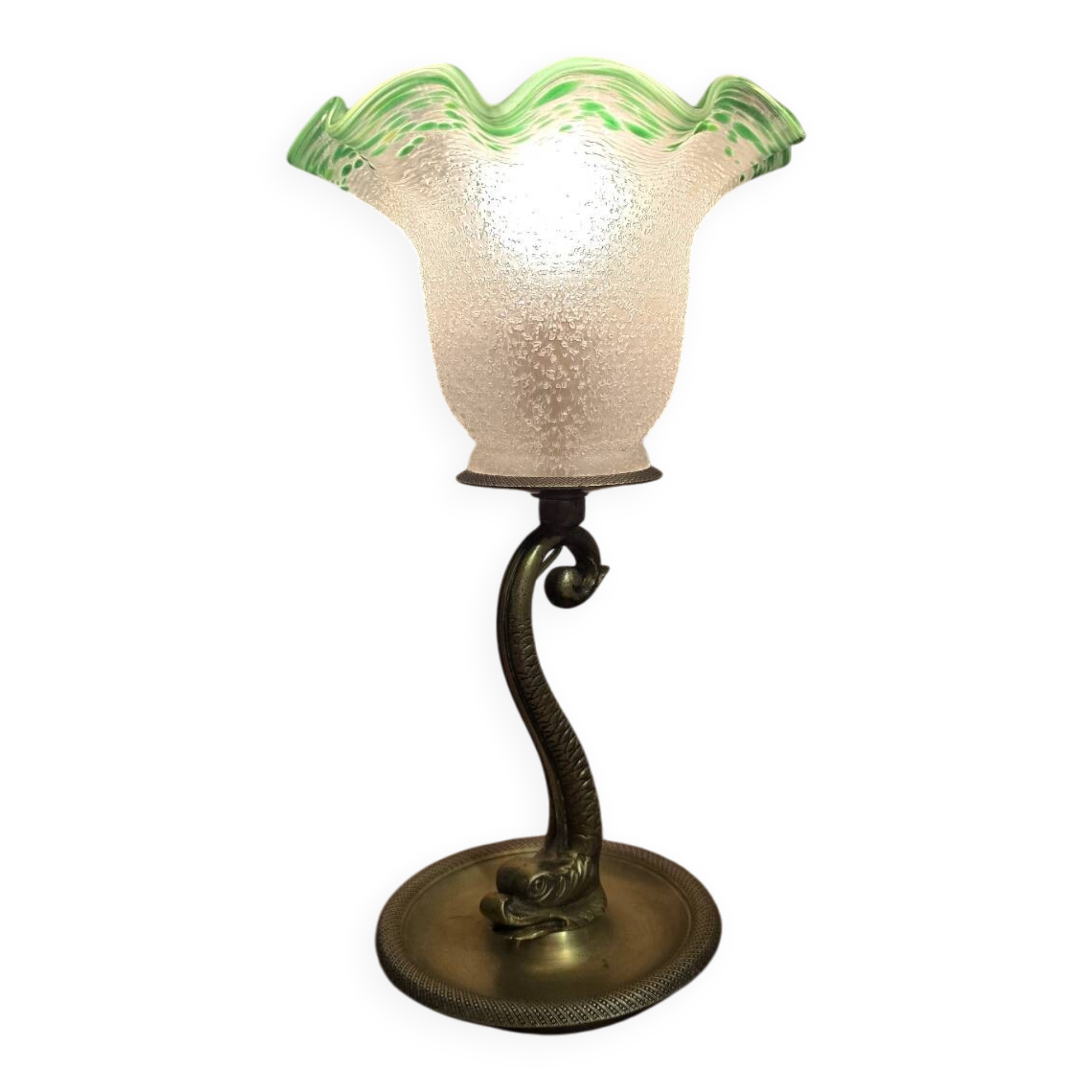 Small table lamp with a brass fish base and a tulip shade with green edges.